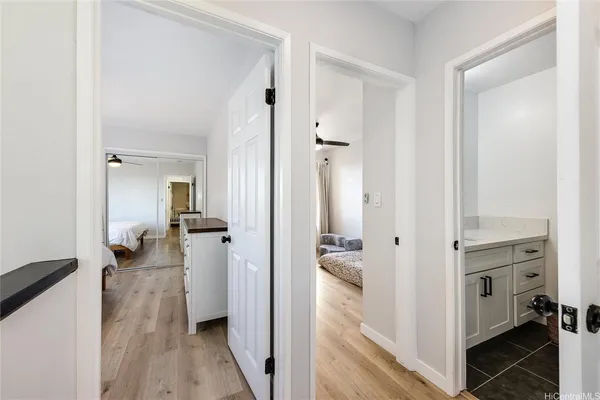 a view of a bathroom with tub and mirrors