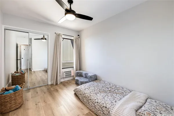 a bedroom with furniture and a window