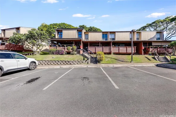 a view of a swimming pool with a patio and a yard