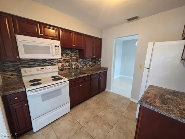 a kitchen with a stove and a refrigerator