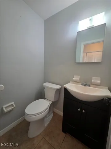 a bathroom with a sink toilet and mirror