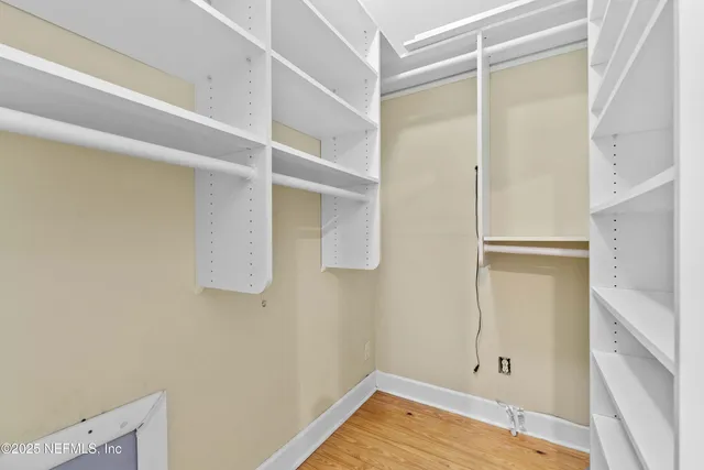 a view of a room with wooden floor and cabinet