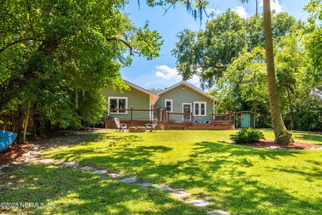 a front view of a house with swimming pool and porch