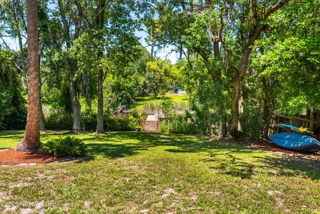 a view of a golf course with a tree