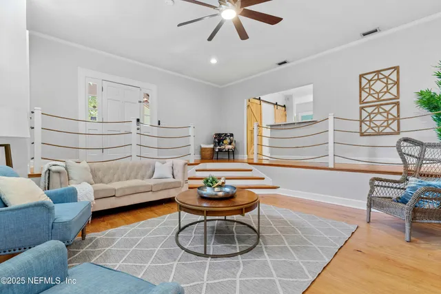 a living room with furniture a rug and a window