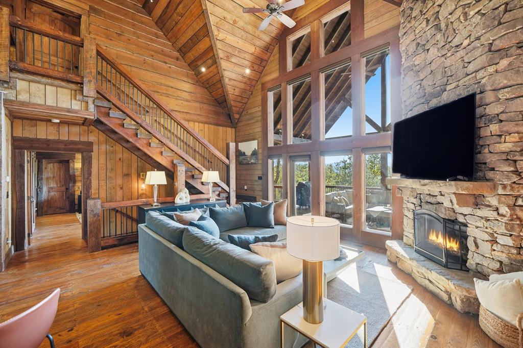 249 Settlement Road Epworth, GA 30541 - Photo 14 of 43 a view of a building with couches chairs and a flat screen tv