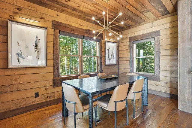 a view of a dining room with furniture large window and wooden floor