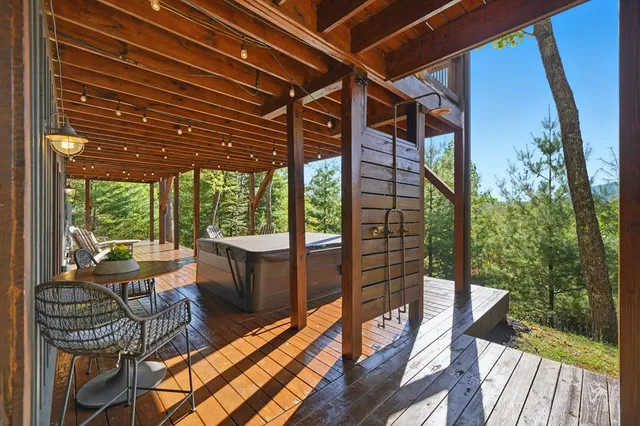 a view of a patio with table and chairs and wooden floor