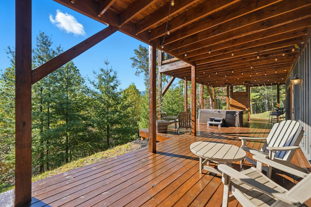 249 Settlement Road Epworth, GA 30541 - Photo 24 of 43 a view of a patio with table and chairs potted plants with wooden floor and floor to ceiling window