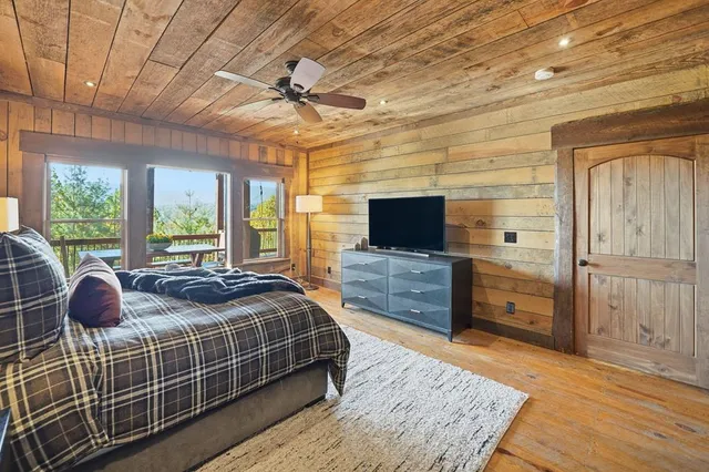 a bathroom with a granite countertop sink a toilet a mirror and shower