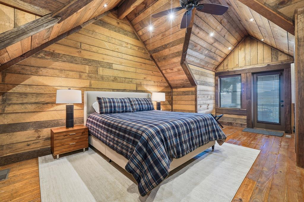 249 Settlement Road Epworth, GA 30541 - Photo 28 of 43 a spacious bedroom with a bed and wooden floor