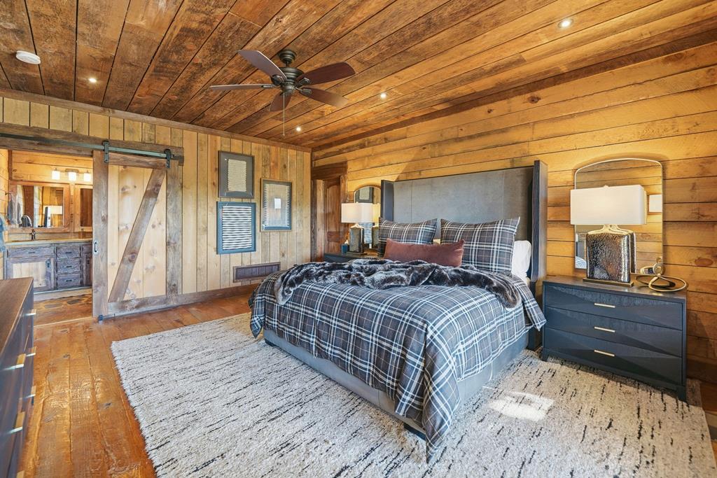 249 Settlement Road Epworth, GA 30541 - Photo 29 of 43 a bedroom with a large bed and wooden floor