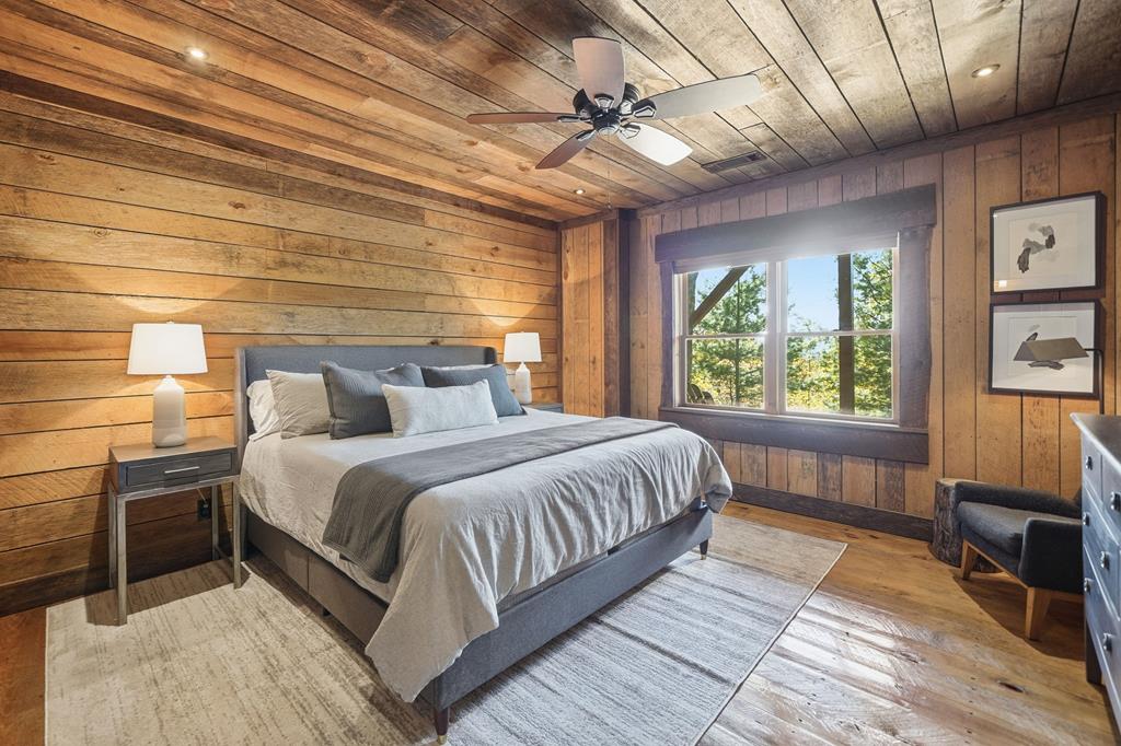 249 Settlement Road Epworth, GA 30541 - Photo 33 of 43 a bedroom with a large bed and a chandelier