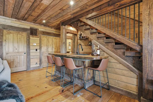 a dining room with wooden floor and window