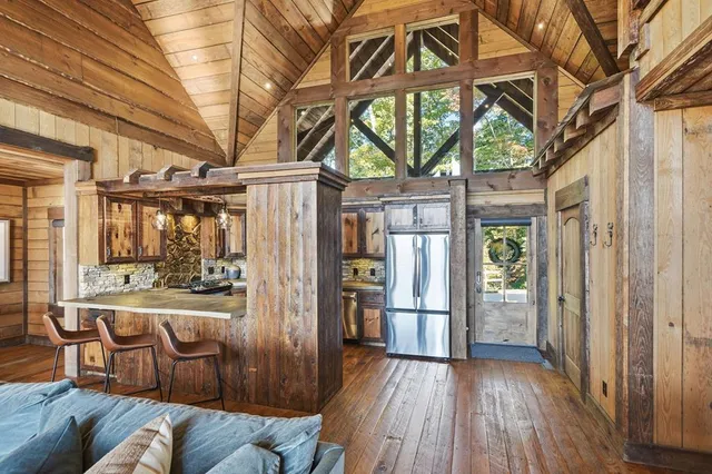 a view of a living room with a large window and wooden floor