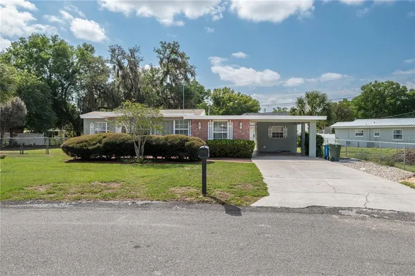 a front view of a house with a yard and a garage