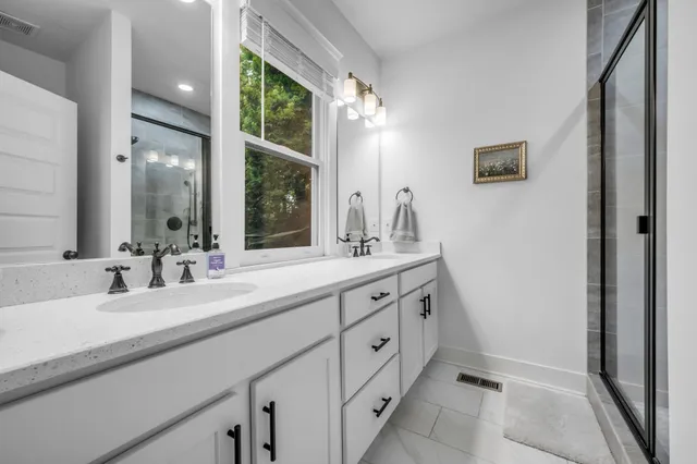 a bathroom with double sink and a mirror