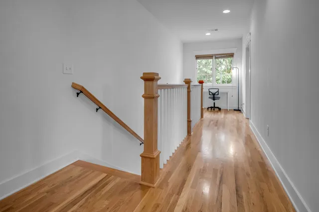 a view of a hallway view with wooden floor and staircase