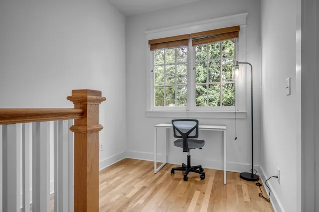 a view of a room with a window and wooden floor