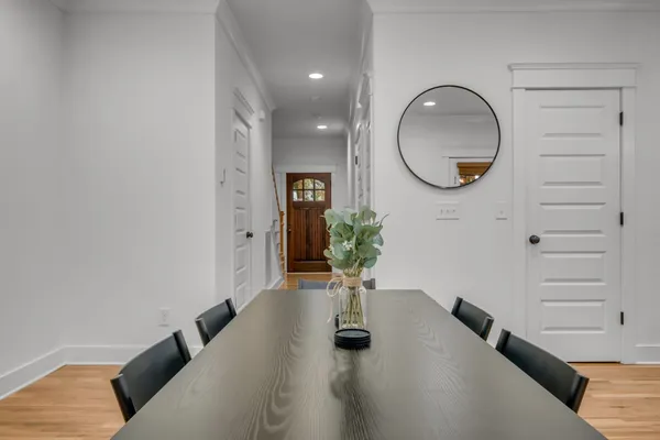 a living room with furniture and a mirror