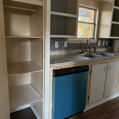 a kitchen with a refrigerator and a sink
