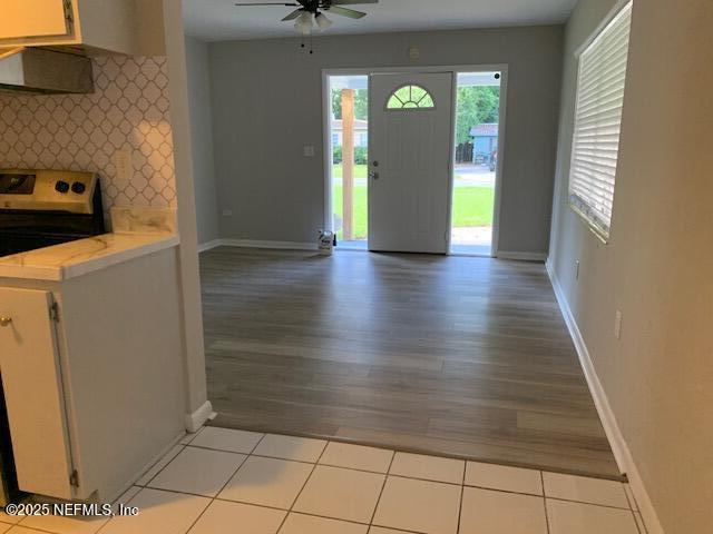 1122 West Pratt Street Starke, FL 32091 - Photo 4 of 7 a view of an empty room with window and wooden floor