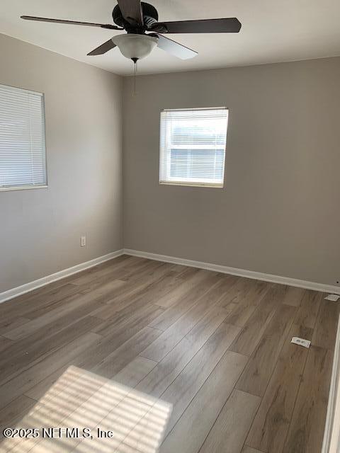 1122 West Pratt Street Starke, FL 32091 - Photo 6 of 7 a view of an empty room with wooden floor and a window