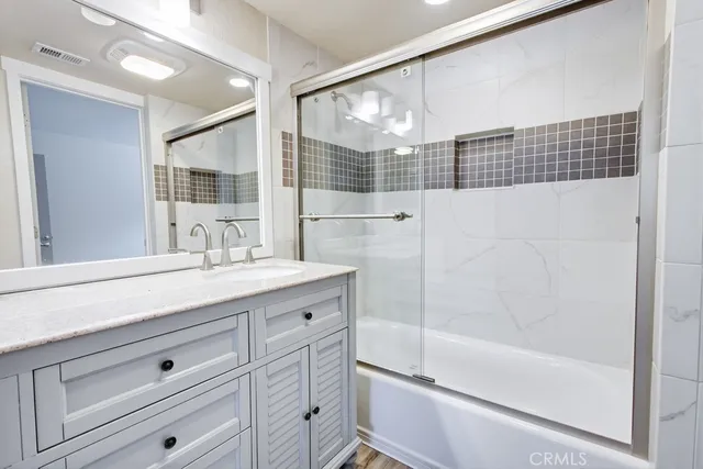 a bathroom with a granite countertop sink mirror and double