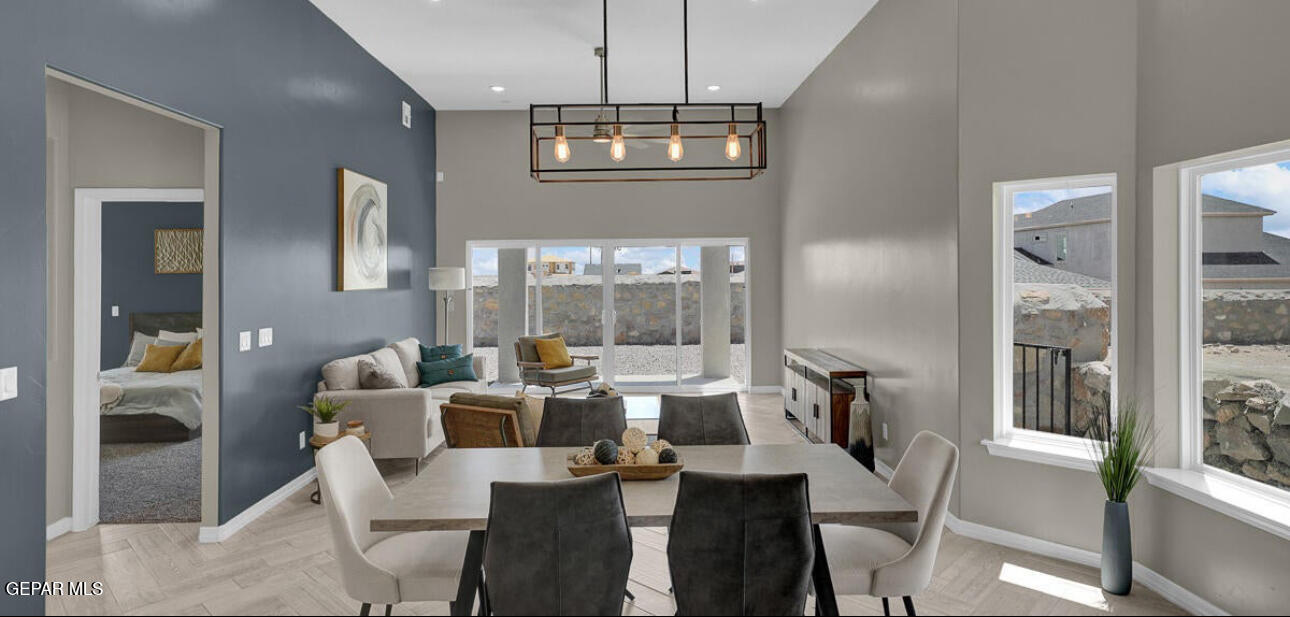 12422 Fill Ball Street El Paso, TX 79928 - Photo 12 of 32 a view of a dining room with furniture wooden floor and chandelier