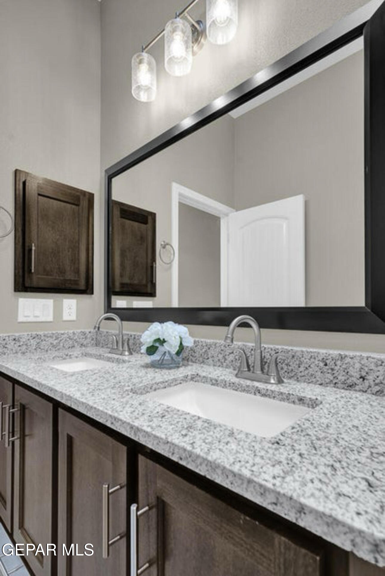 12422 Fill Ball Street El Paso, TX 79928 - Photo 29 of 32 a bathroom with a granite countertop sink and a mirror