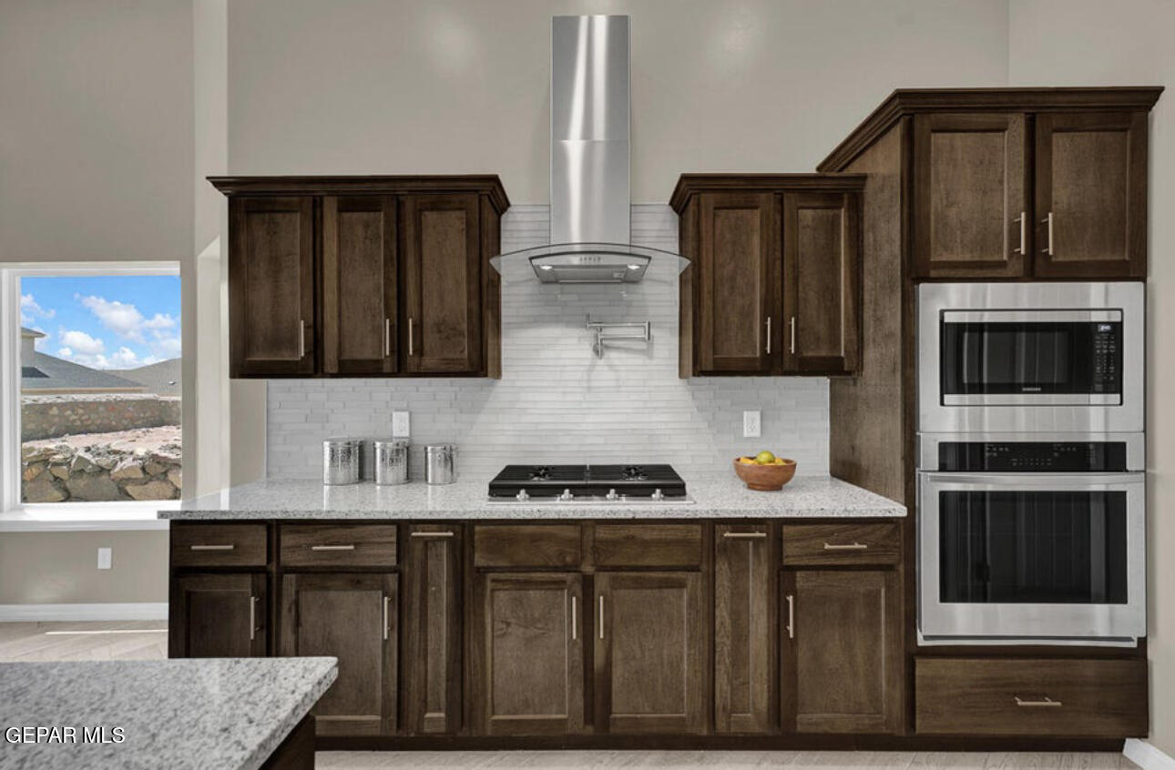 12422 Fill Ball Street El Paso, TX 79928 - Photo 5 of 32 a kitchen with stainless steel appliances a stove and a microwave