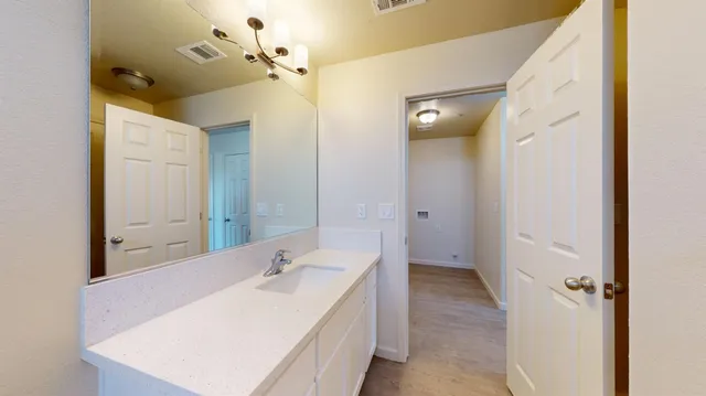 a view of staircase with lots of frames and wooden floor