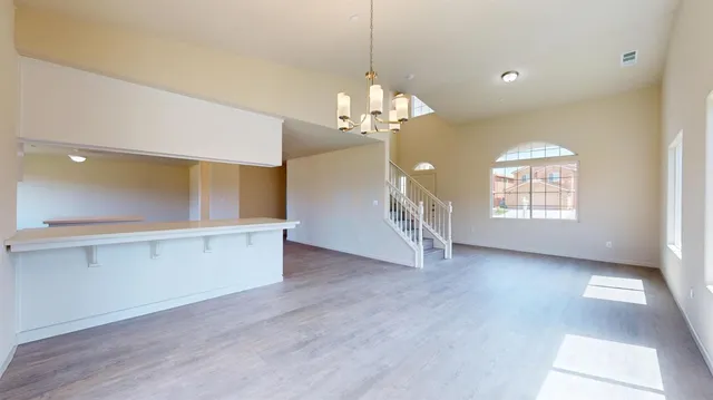 a view of a big room with windows and chandelier