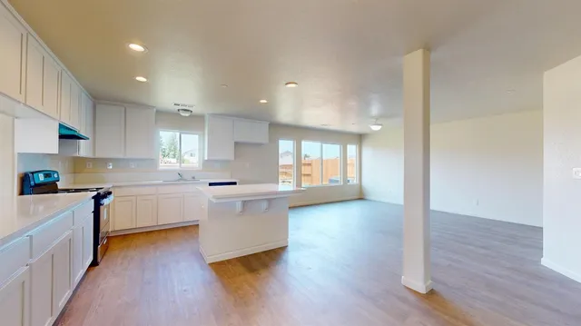 a kitchen with a stove a sink and a refrigerator
