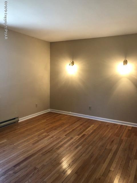 707 Dotters Corner Road Kunkletown, PA 18058 - Photo 11 of 18 an empty room with wooden floor and windows
