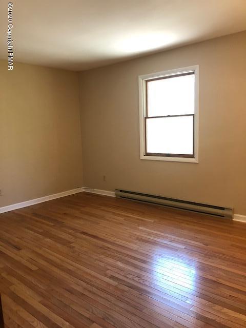 707 Dotters Corner Road Kunkletown, PA 18058 - Photo 13 of 18 an empty room with wooden floor and windows
