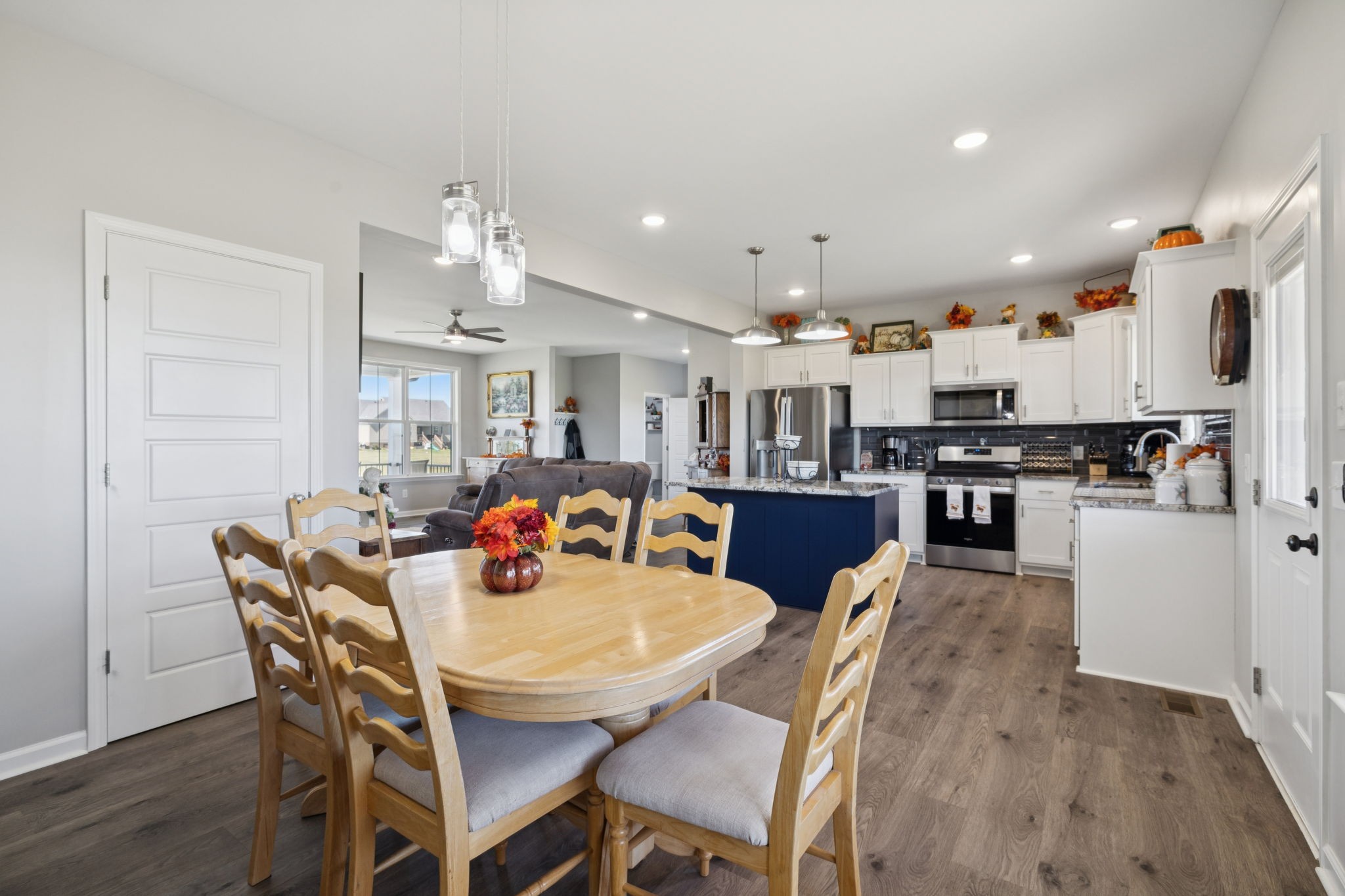 5373 East Robertson Road Orlinda, TN 37141 - Photo 23 of 57 a kitchen with stainless steel appliances kitchen island granite countertop a dining table chairs and a refrigerator