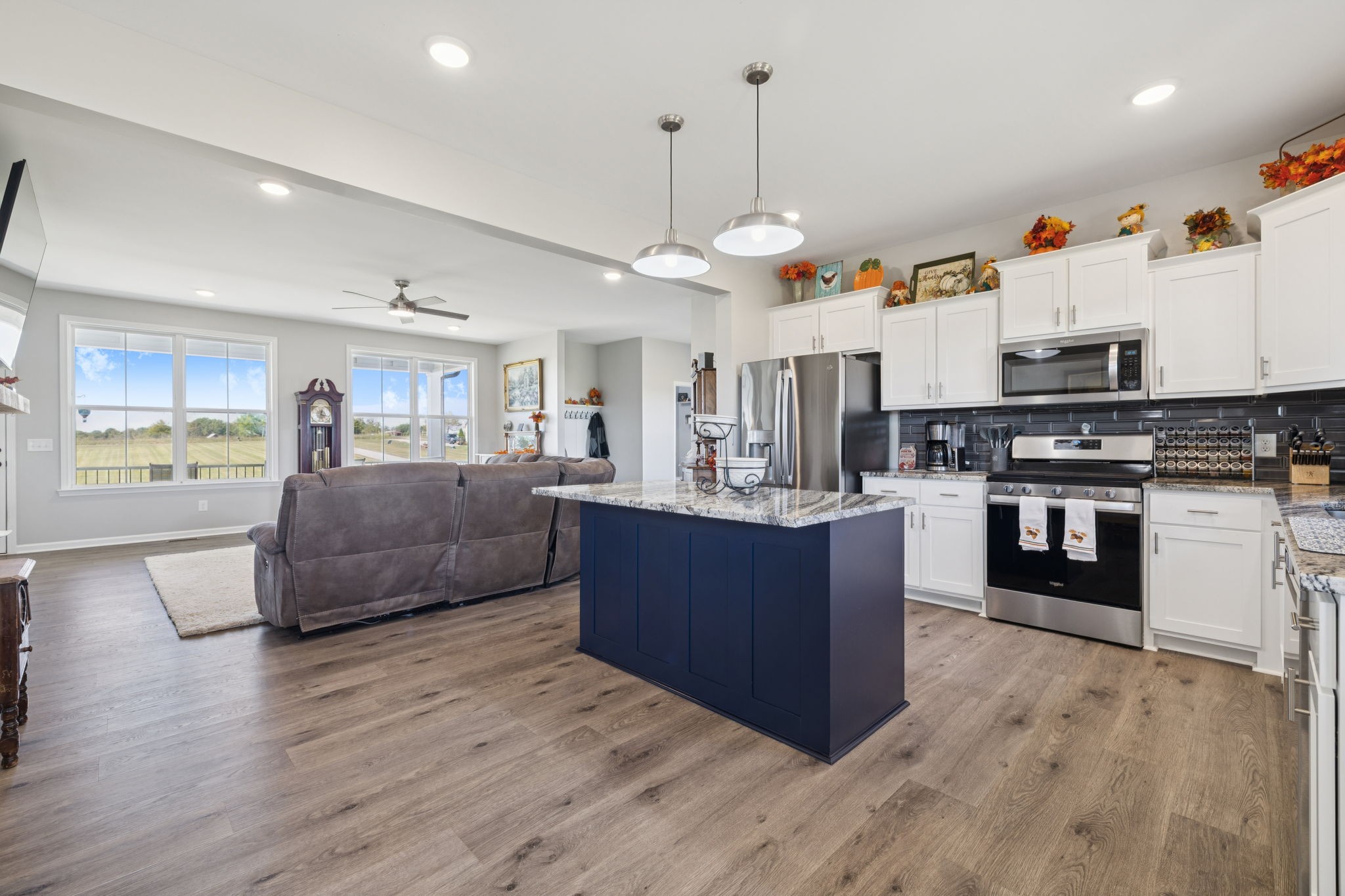 5373 East Robertson Road Orlinda, TN 37141 - Photo 32 of 57 a large kitchen with stainless steel appliances kitchen island granite countertop a stove a sink a refrigerator and a wooden floor