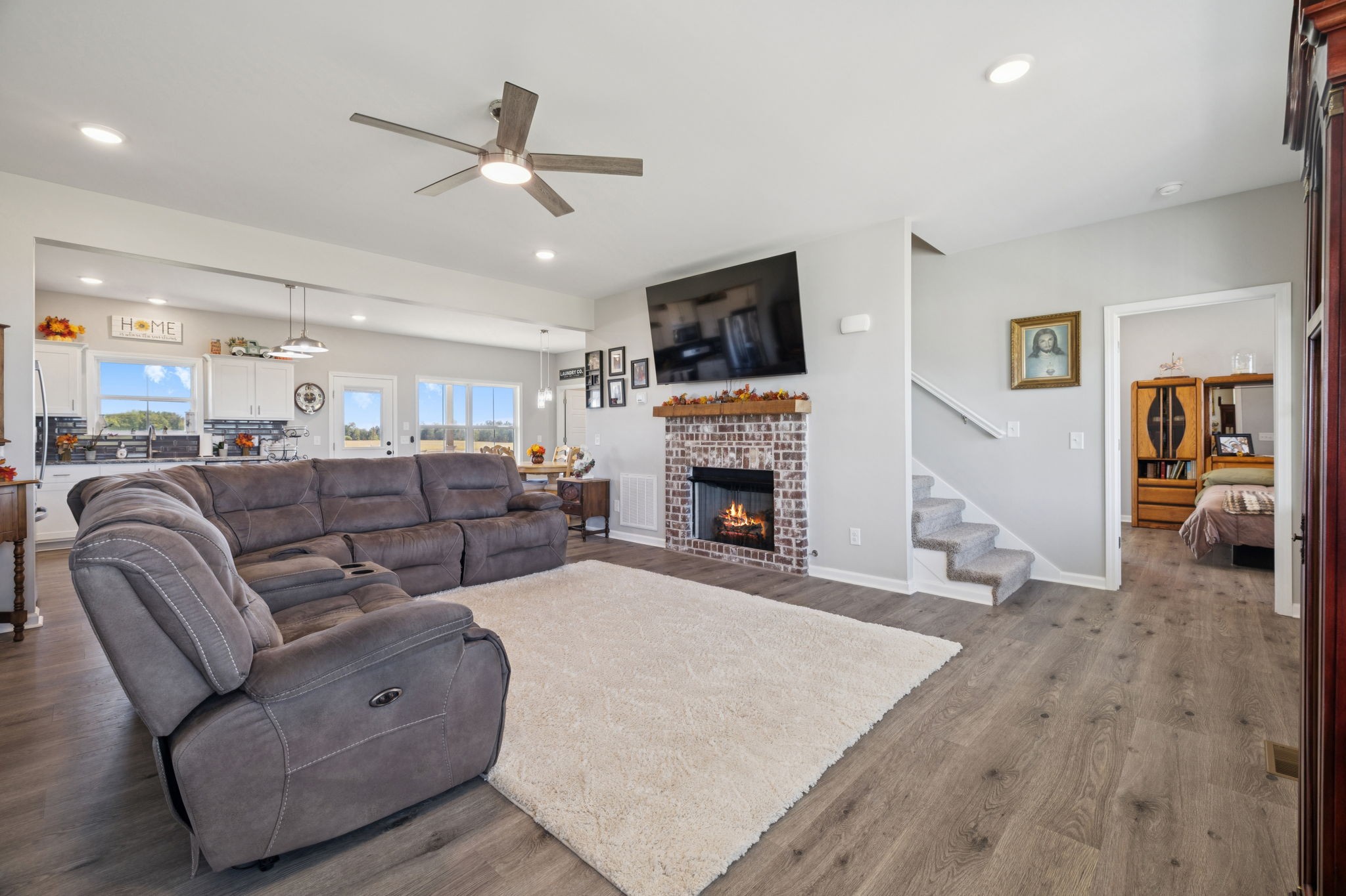 5373 East Robertson Road Orlinda, TN 37141 - Photo 6 of 57 a living room with furniture a fireplace and a flat screen tv