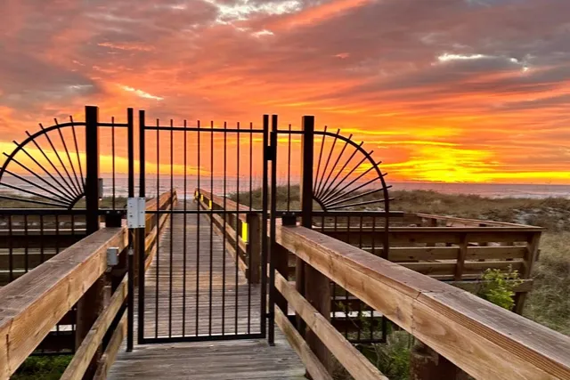a view of balcony with wooden floor and fence