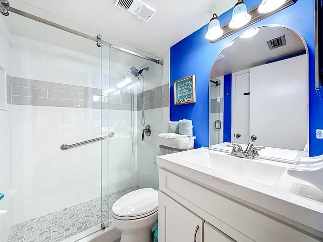 a bed sitting in a spacious bedroom next to a window