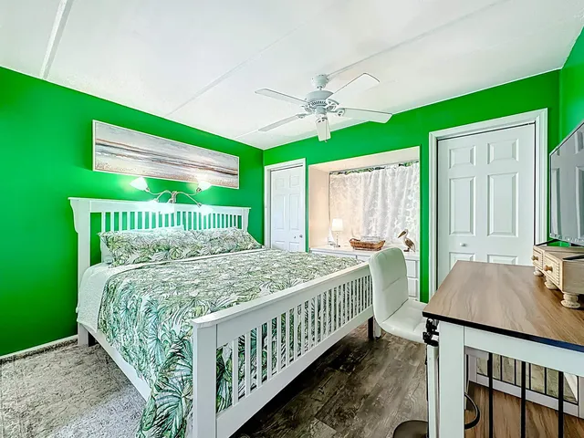 a bed sitting in a bedroom next to a window