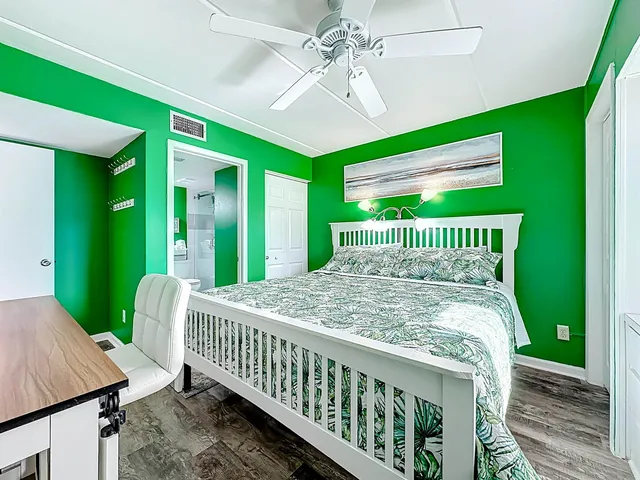 a bedroom with a bed and a television