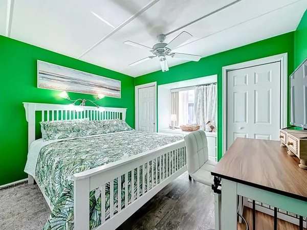 a view of yellow house with flower plants