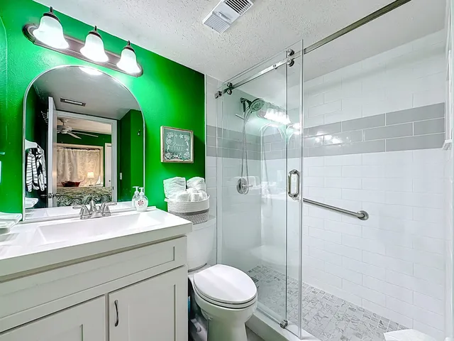 a view of yellow house with flower plants