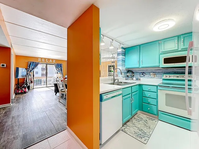 a kitchen with stainless steel appliances kitchen island granite countertop a stove a sink and a microwave