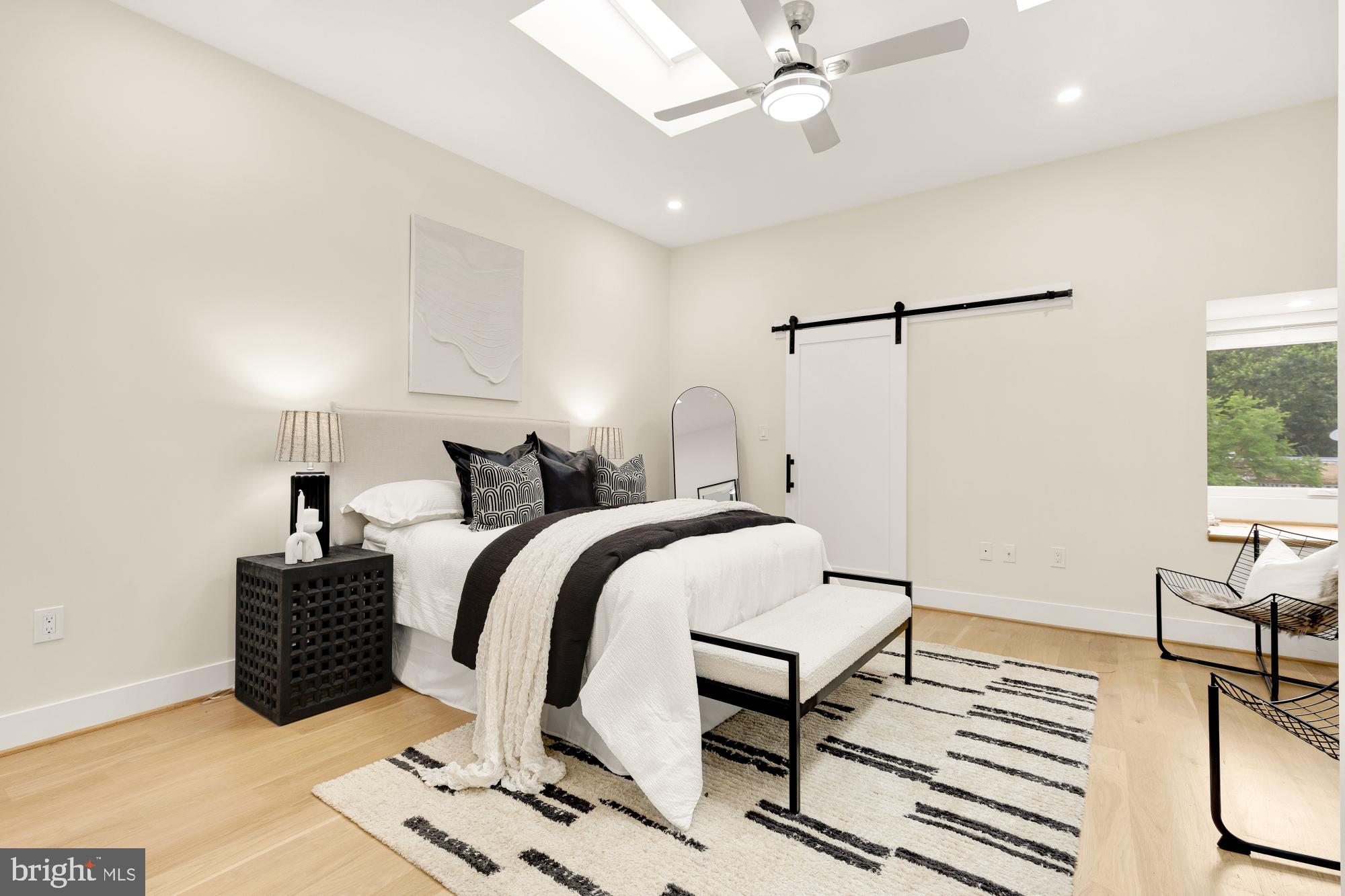 41 Q Street Northeast, Unit 2 Washington, DC 20002 - Photo 13 of 27 a bedroom with a bed and a chandelier