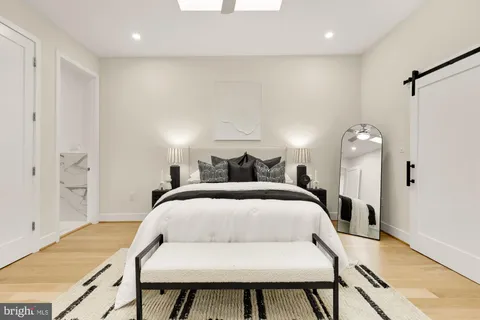 a bedroom with a bed and a chandelier