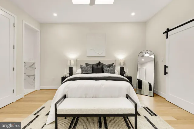 a bedroom with a bed and a chandelier