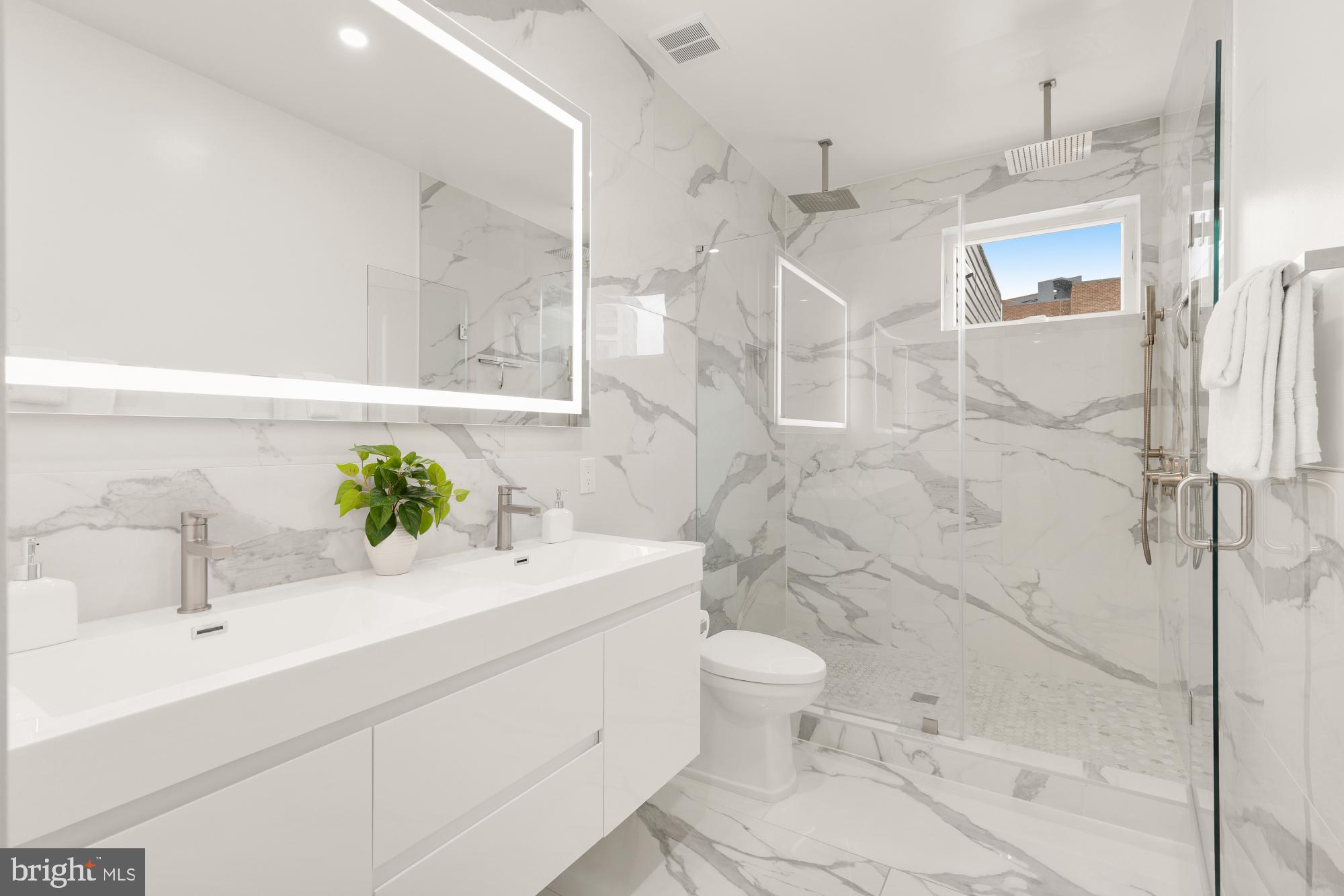 41 Q Street Northeast, Unit 2 Washington, DC 20002 - Photo 15 of 27 a bathroom with a sink toilet and shower